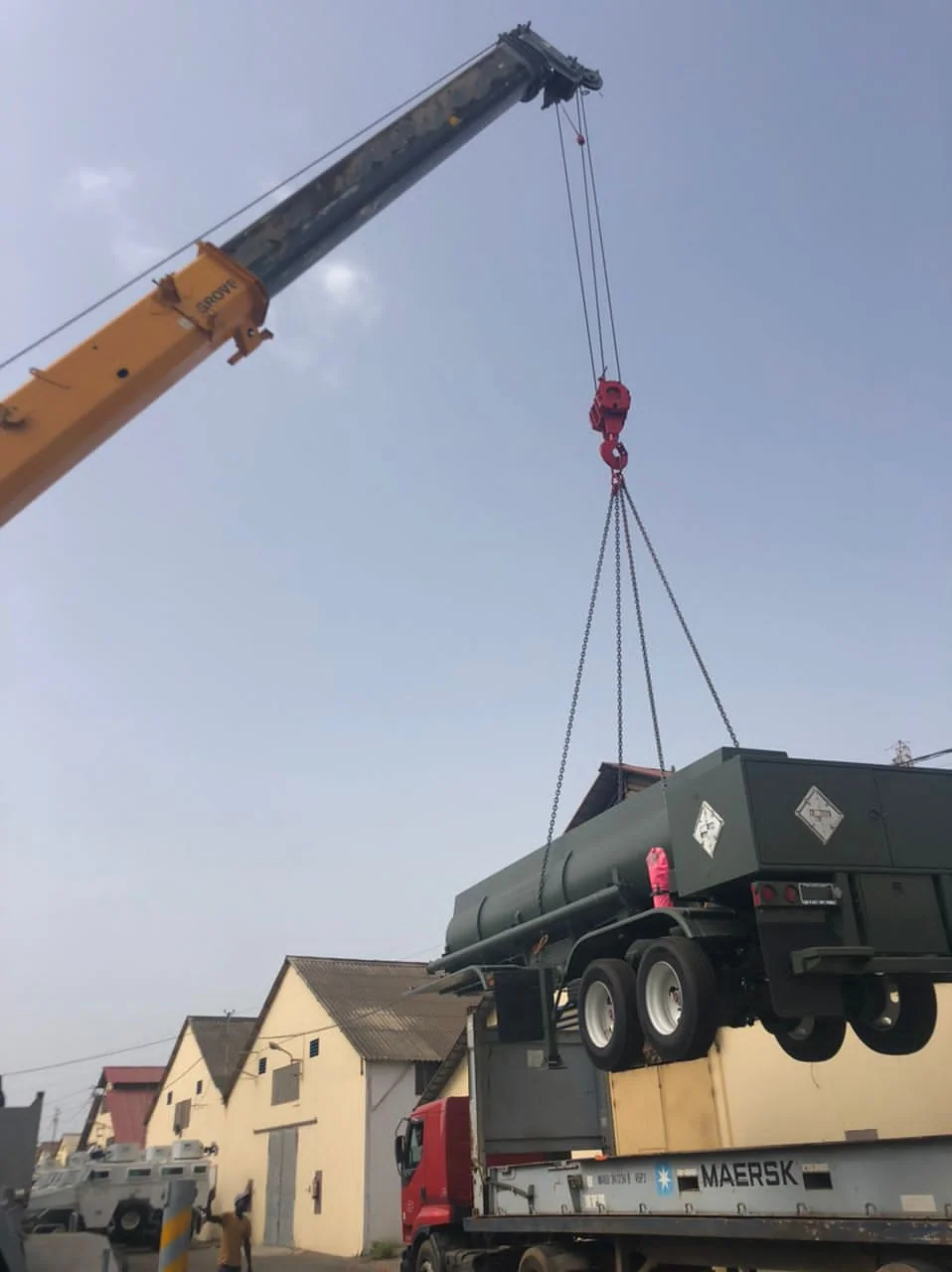 Grove crane lifting a tanker trailer on a four-leg sling